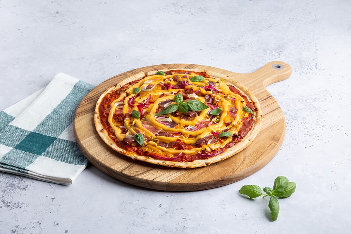 Modern Pizza Builds Start With Sauce - AFP